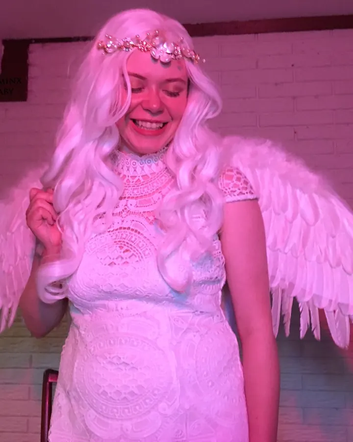 Femme trans européenne aux cheveux blonds, posant de face, avec un pénis artificiel visible sous un slip blanc, regardant l'objectif